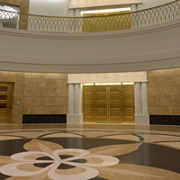 A view toward the doors to the first-floor Court of Appeals courtroom, and the stone columbine flower inlaid in the atrium floor.